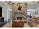Bright living room with stone fireplace, wood floors, and comfortable seating at 700 Bear Shadow Ct, Longwood, FL 32779