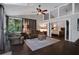 Sun-filled living room featuring dark hardwood floors and view to the primary bedroom at 700 Bear Shadow Ct, Longwood, FL 32779