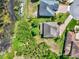 Aerial view of homes showcasing manicured lawns and a serene pond at 732 Wildmere Village Cv, Longwood, FL 32750