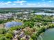 A wider aerial view of the surrounding areas shows the lakes and the extensive tree coverage at 732 Wildmere Village Cv, Longwood, FL 32750