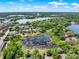 An aerial landscape showcasing the surrounding lake communities and beautiful tree coverage at 732 Wildmere Village Cv, Longwood, FL 32750