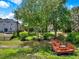 Spacious backyard with pond access, featuring lush trees, and a wooden deck with seating at 732 Wildmere Village Cv, Longwood, FL 32750