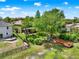 Aerial view of a spacious backyard with waterfront access, a firepit, and a kayak at 732 Wildmere Village Cv, Longwood, FL 32750