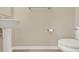 Bathroom featuring a pedestal sink, toilet, and a neutral-toned wall at 732 Wildmere Village Cv, Longwood, FL 32750