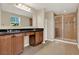 Bathroom featuring double sinks, a granite countertop, a vanity with cabinet space and a glass-enclosed shower at 732 Wildmere Village Cv, Longwood, FL 32750