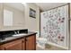 Cozy bathroom with a vanity, granite countertop, and a shower/tub combination with a floral shower curtain at 732 Wildmere Village Cv, Longwood, FL 32750