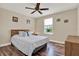 Simple bedroom with neutral walls, ceiling fan, and window with natural light at 732 Wildmere Village Cv, Longwood, FL 32750