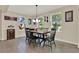 Charming dining room with large windows, a modern chandelier, and seating for six at 732 Wildmere Village Cv, Longwood, FL 32750