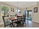 Bright dining area with tile floors, large windows, slider to outdoor patio, and seating for four at 732 Wildmere Village Cv, Longwood, FL 32750