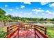 Lakeside retreat featuring a cozy dock with seating, ideal for enjoying serene pond views at 732 Wildmere Village Cv, Longwood, FL 32750
