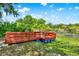 Charming wooden dock with pontoon floats offering a peaceful waterfront escape with scenic pond views at 732 Wildmere Village Cv, Longwood, FL 32750
