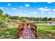 Charming wooden dock on a tranquil pond, perfect for relaxing and enjoying the natural surroundings at 732 Wildmere Village Cv, Longwood, FL 32750