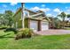 Beautiful green home with three-car garage, brick paver driveway and well-manicured lawn at 732 Wildmere Village Cv, Longwood, FL 32750