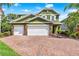 Inviting two-story home featuring a three-car garage and brick paver driveway at 732 Wildmere Village Cv, Longwood, FL 32750