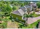 A side aerial showcases the house with neat landscaping and a brick-paved driveway at 732 Wildmere Village Cv, Longwood, FL 32750