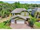 An overhead front elevation view of the house with a two-car garage and brick-paved driveway at 732 Wildmere Village Cv, Longwood, FL 32750