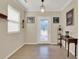 Light-filled foyer features neutral walls, tile floors, and a glass-paneled front door at 732 Wildmere Village Cv, Longwood, FL 32750