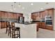 Well-lit kitchen with stainless steel appliances, granite countertops, and a convenient breakfast bar at 732 Wildmere Village Cv, Longwood, FL 32750