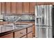 Close-up of kitchen island featuring granite countertops and modern stainless steel appliances at 732 Wildmere Village Cv, Longwood, FL 32750