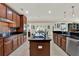 Gourmet kitchen featuring stainless appliances, granite countertops, and open layout to the dining area at 732 Wildmere Village Cv, Longwood, FL 32750