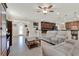 Open-concept living room and kitchen with tile floors, modern lighting and access to the front foyer at 732 Wildmere Village Cv, Longwood, FL 32750