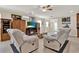 Spacious living room with tile floors, ceiling fan, fireplace, and comfortable seating at 732 Wildmere Village Cv, Longwood, FL 32750