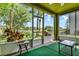 Screened porch with outdoor seating and a view of the yard and pond at 732 Wildmere Village Cv, Longwood, FL 32750