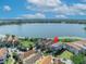 Beautiful home aerial view on a scenic lake, featuring lush landscaping and a stunning waterside setting at 7613 Toscana Blvd, Orlando, FL 32819