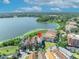Aerial view of lakefront home with scenic views, lush landscaping, and a serene atmosphere at 7613 Toscana Blvd, Orlando, FL 32819