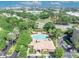 Aerial view of a clubhouse and community pool with ample parking, surrounded by mature landscaping and convenient access at 7613 Toscana Blvd, Orlando, FL 32819