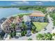 Aerial view showcasing luxury homes near a scenic lake at 7613 Toscana Blvd, Orlando, FL 32819