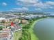 Aerial view of lakefront home near local amenities, featuring a stunning view of a serene waterside setting at 7613 Toscana Blvd, Orlando, FL 32819