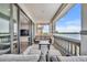 Balcony with ornate stone railing with lounge furniture, tile floors, and a view of the lake at 7613 Toscana Blvd, Orlando, FL 32819