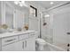 Bright bathroom with glass shower enclosure, white cabinets, and modern fixtures at 7613 Toscana Blvd, Orlando, FL 32819