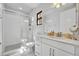 Modern bathroom with a glass-enclosed shower, vanity with storage, and marble floors for a luxurious feel at 7613 Toscana Blvd, Orlando, FL 32819