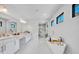 Bright, spacious bathroom featuring double vanities, freestanding tub, and marble flooring at 7613 Toscana Blvd, Orlando, FL 32819