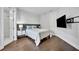 Comfortable bedroom featuring hardwood floors, neutral walls, and modern fixtures at 7613 Toscana Blvd, Orlando, FL 32819