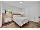 Bright bedroom featuring a modern bed frame, stylish bedside tables, and hardwood floors at 7613 Toscana Blvd, Orlando, FL 32819