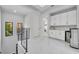 Upstairs hallway features a laundry area with modern appliances and ample storage space at 7613 Toscana Blvd, Orlando, FL 32819