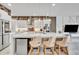 Bright kitchen featuring white cabinets, stainless steel appliances, pendant lighting, and a large central island with seating at 7613 Toscana Blvd, Orlando, FL 32819