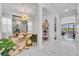 Open-concept home interior featuring modern lighting, white tile floors, and arched doorways at 7613 Toscana Blvd, Orlando, FL 32819