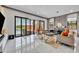 Open living room featuring a sliding glass door to the pool, comfortable seating, and modern decor against neutral walls at 7613 Toscana Blvd, Orlando, FL 32819