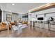 Large living room with hardwood floors, leather furniture and a built in study space with chairs and TV at 7613 Toscana Blvd, Orlando, FL 32819