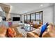 Bright living room extends to balcony with sliding glass doors, and includes comfortable seating with lake views at 7613 Toscana Blvd, Orlando, FL 32819