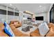 Spacious living room featuring comfortable leather seating, modern decor, and an entertainment center with a large TV at 7613 Toscana Blvd, Orlando, FL 32819