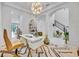 Bright home office featuring modern decor, statement lighting, and sleek white furniture at 7613 Toscana Blvd, Orlando, FL 32819