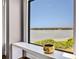 Scenic lake view from a window framed by a sleek white sill, enhancing the room's natural beauty at 7613 Toscana Blvd, Orlando, FL 32819