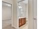 Bathroom featuring wood vanity and tile flooring; bedroom in background at 8296 Portofino Dr # 103, Davenport, FL 33896