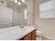 Bright bathroom with a large mirror and wood vanity at 8296 Portofino Dr # 103, Davenport, FL 33896