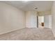 Spacious carpeted bedroom with an open door leading to an ensuite bathroom at 8296 Portofino Dr # 103, Davenport, FL 33896